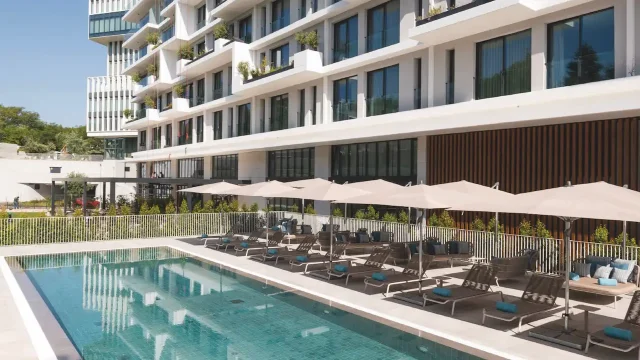 Modern building with poolside loungers