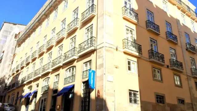 Corner building with balconies and blue sky